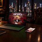 A laptop and a phone on a walnut desk in a members club at night, showing AMBITION wallpapers