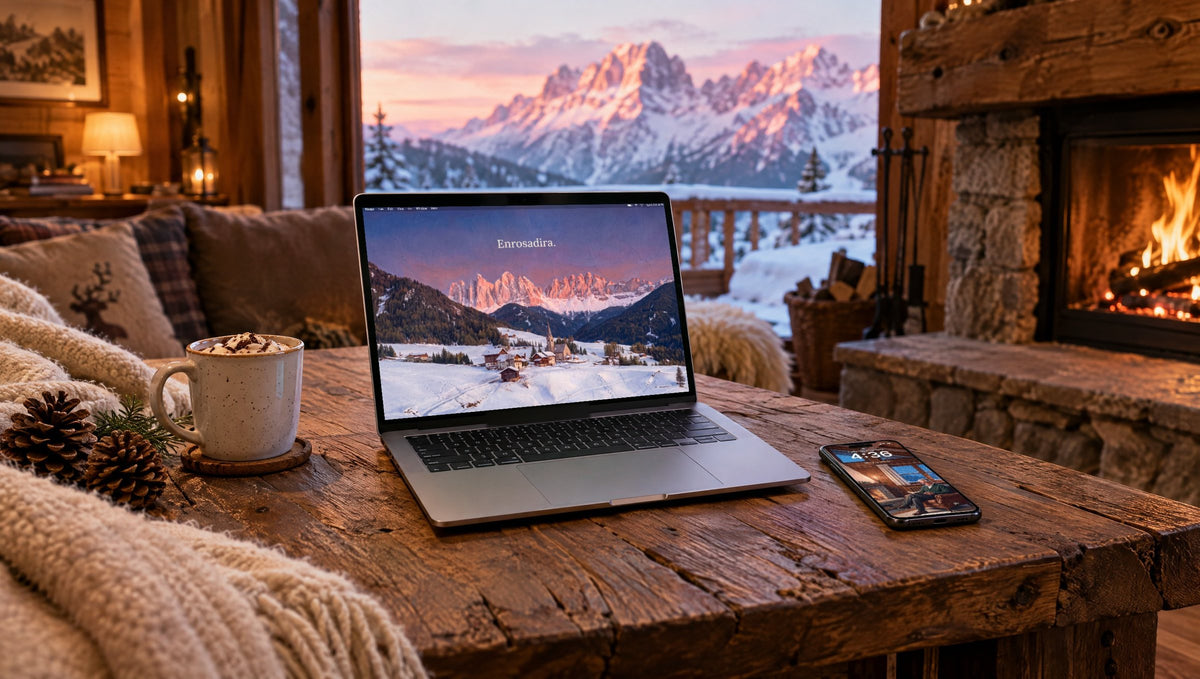 A laptop and a phone in an alpine chalet, showing Enrosadira and Stay a while from QUIET Vol. 3